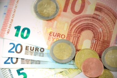 Image of low denomination Euros and coins to illustrate traveling on a budget