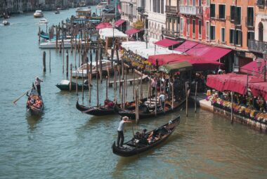 Gondoliers and canal-side restaurants in Venice, Italy